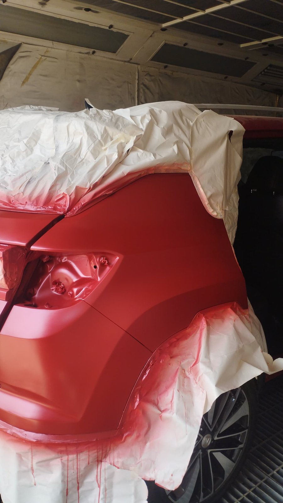 Colour-matched red panel mid-spray